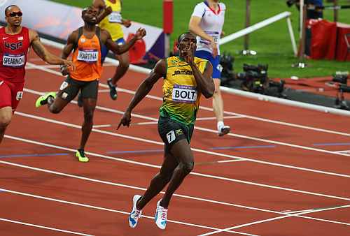 Usain Bolt of Jamaica celebrates as he crosses the finish line to win gold during the Men's 200m final