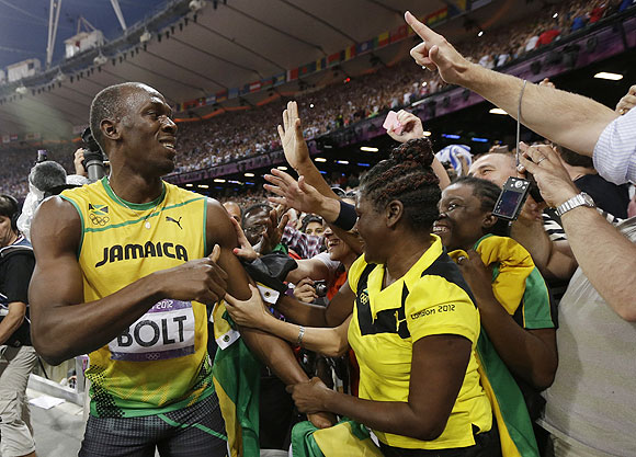 Usain Bolt celebrates his 200m victory with fans on Thursday