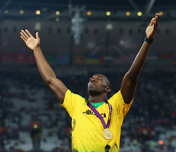 Gold medalist Usain Bolt of Jamaica celebrates during the medal ceremony on Thursday