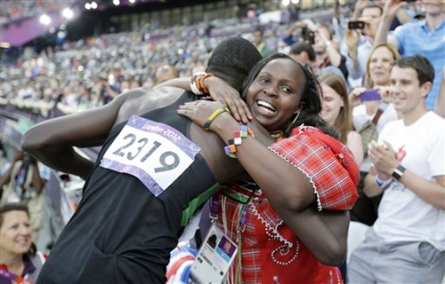 Kenya's David Lekuta Rudisha, left, hugs his wife Lizzy