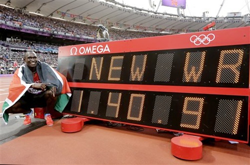 Kenya's David Lekuta Rudisha poses next to a timing board displaying his new world record