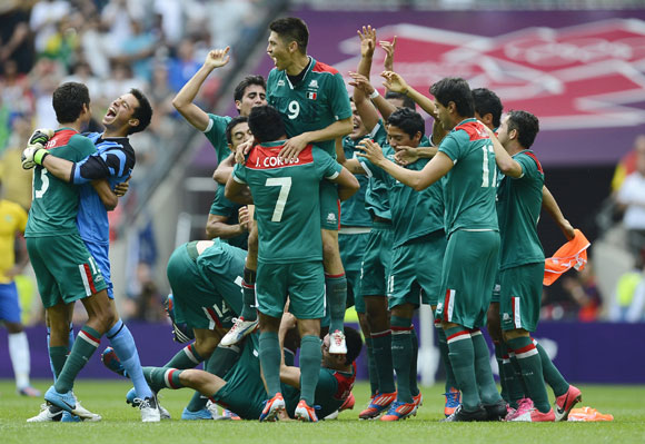 Mexico's players celebrate their victory over Brazil after their men's soccer final gold medal match at Wembley Stadium