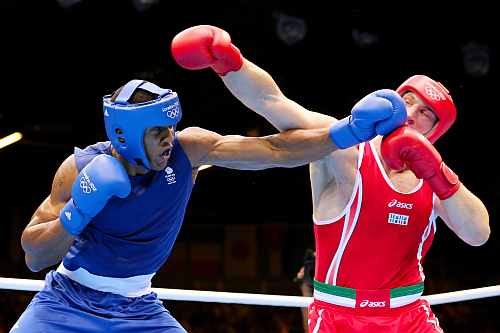 Anthony Joshua (L) of Great Britain exchanges punches with Roberto Cammarelle (R) of Italy during the Men's Super Heavy (+91kg) Boxing final bout