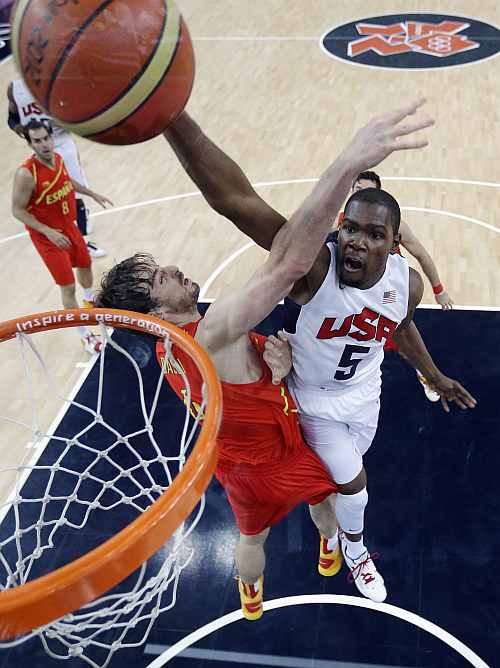United States' Kevin Durant (5) slam dunks to score over Spain's Pau Gasol, left, during the Men's Basketball Gold medal game between the United States and Spain