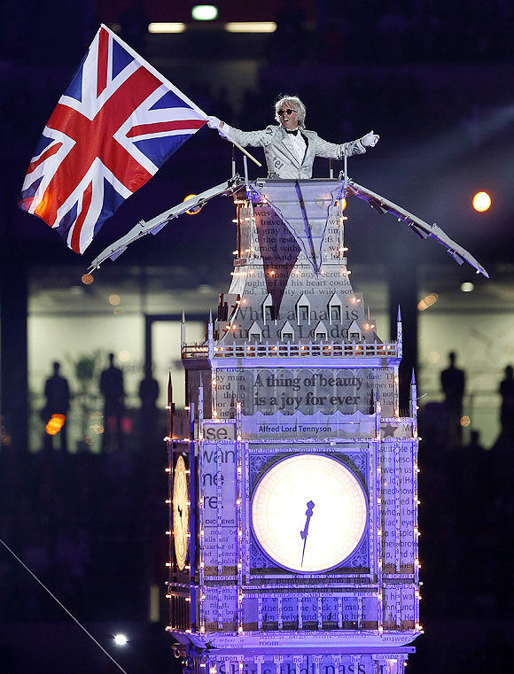 A performer, dressed as Winston Churchill, stands atop the Big Ben as he participates in the closing ceremony of the London 2012 Olympic Games