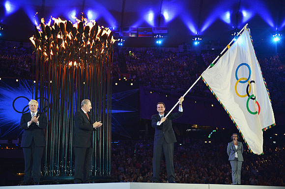 The Olympic Flag is handed from Mayor of London, Boris Johnson to IOC President Jacques Rogge, who passes it to Mayor of Rio de Janeiro, Eduardo Paes during the Closing Ceremony