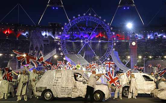 Performers wave British flags during the closing ceremony