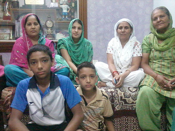 Sushil's mother Kamla Devi (2nd from right) and other relatives await his arrival at his home in Najafgarh
