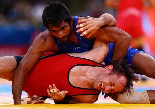 ogeshwar Dutt of India in action against Anatolie Ilarionovitch Gudea of Bulgaria in the Men's Freestyle Wrestling