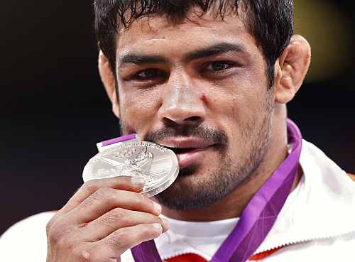 India's Sushil Kumar poses with his silver medal at the podium of the Men's 66Kg Freestyle wrestling