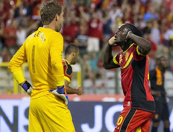 Romelu Lukaku of Belgium (right) celebrates as Netherlands goalkeeper Maarten Stekelenburg looks dejected during their soccer friendly at the King Baudouin stadium in Brussels