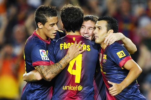 Lionel Messi of FC Barcelona (second right) celebrates with his teammates after scoring   their second goal