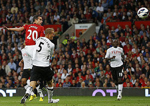Manchester United's Robin van Persie (left) scores against Fulham during their English Premier League match on Saturday