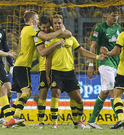 Borussia Dortmund's Marco Reus (eft), Mario Goetze (2nd from right) and Robert Lewandowski celebrate a goal against Werder Bremen on Friday