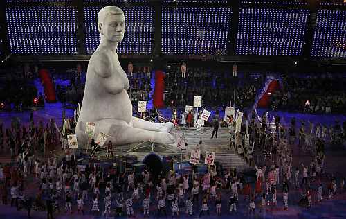 Performers hold placards next to giant statue as they take part at opening ceremony of London 2012 Paralympic Games in Olympic Stadium
