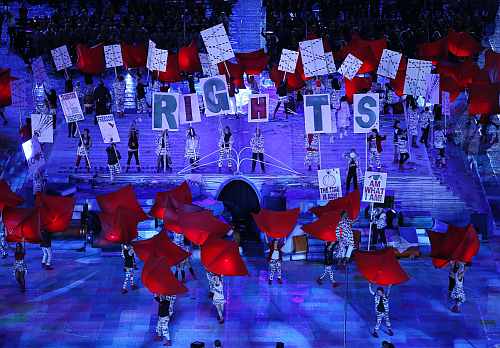Performers hold placards as they take part at opening ceremony of London 2012 Paralympic Games in Olympic Stadium