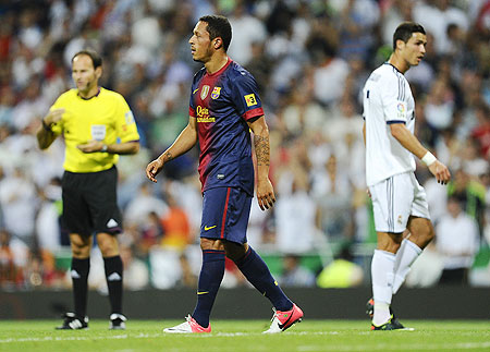 Barcelona's Adriano Correia (centre) leaves the pitch after being shown a red card for a challenge on Cristiano Ronaldo on Wednesday
