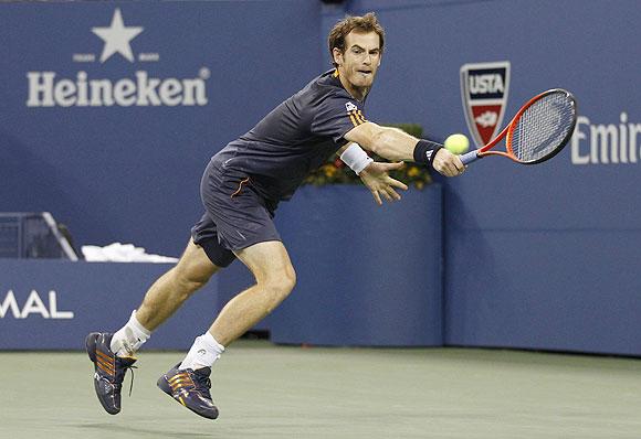 Andy Murray of Britain returns a shot to Ivan Dodig of Croatia