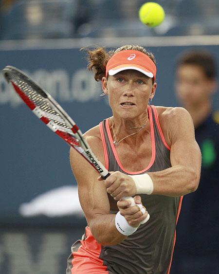 Samantha Stosur of Australia returns a shot to Edina Gallovits-Hall of Romania