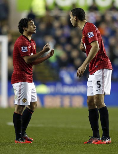 Manchester United's Rafael (L) speaks to to team mate Rio Ferdinand during their English Premier League soccer match against Reading at the Madejski Stadium in Reading