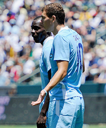 Manchester City's Edin Dzeko with teammate Mario Balotelli