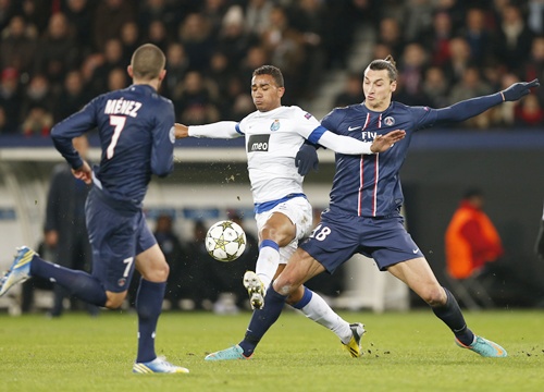 Paris St Germain's Zlatan Ibrahimovic (right) challenges FC Porto's Danilo