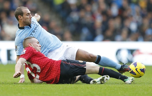 Manchester City's Pablo Zabaleta (top) challenges Manchester United's Tom Cleverley