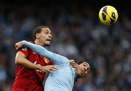 Manchester City's Carlos Tevez (right) challenges Manchester United's Rio Ferdinand on Sunday