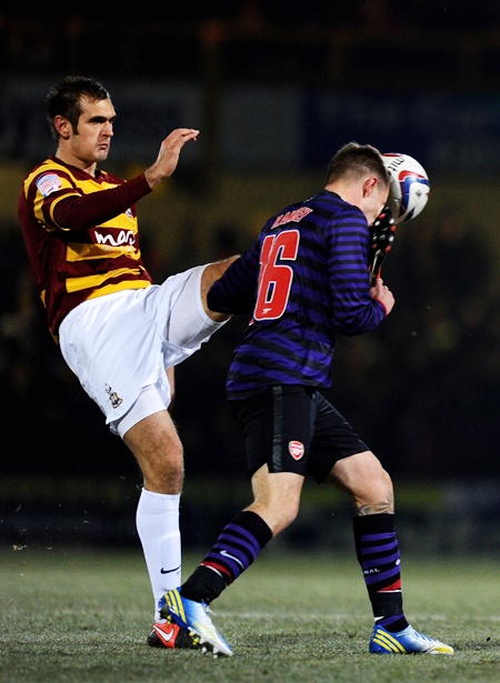 James Hanson of Bradford makes contact with the face of Aaron Ramsey of Arsenal