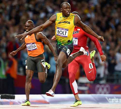 Usain Bolt crosses the finish line to clinch the 100m gold