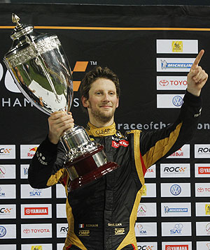 Driver Romain Grosjean from Team France holds up Race of Champions (ROC) trophy after winning on Sunday