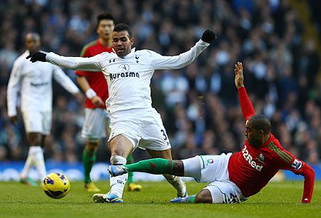 Kemy Agustien of Swansea City tackles Sandro of Tottenham Hotspur on Sunday