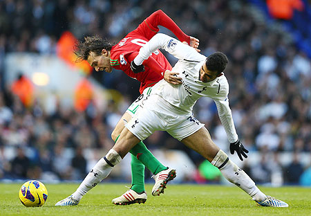 Michu of Swansea City and Sandro of Tottenham Hotspur battle for the ball during their match on Sunday