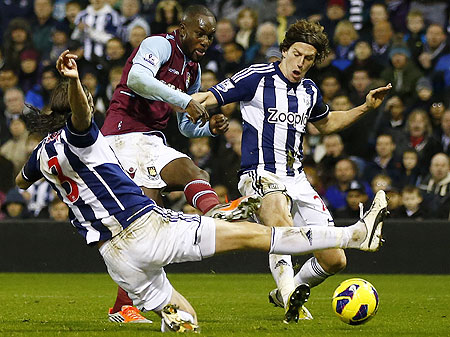 West Ham United's Carlton Cole (cole) is challenged by West Bromwich Albion's Billy Jones (right) and Jonas Olsson during their match on Sunday
