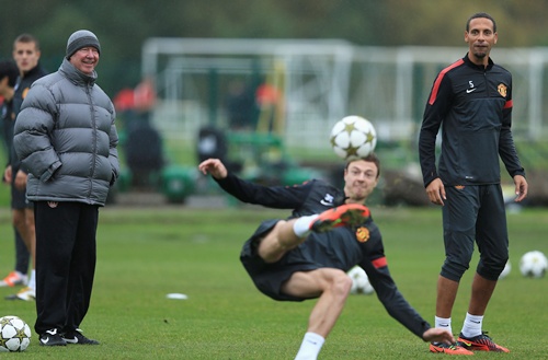 Sir Alex Ferguson jokes with Rio Ferdinand during the Manchester United Training