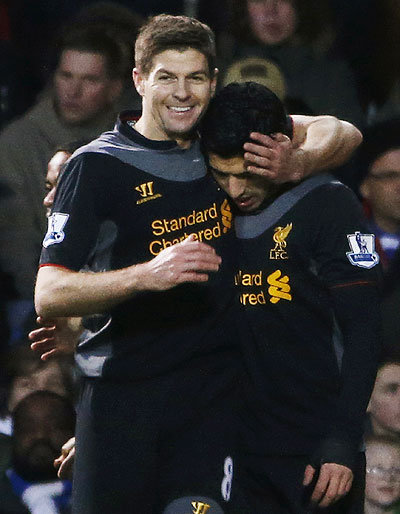 Liverpool's Luis Suarez (right) celebrates with teammate Steven Gerrard after scoring against Queens Park Rangers