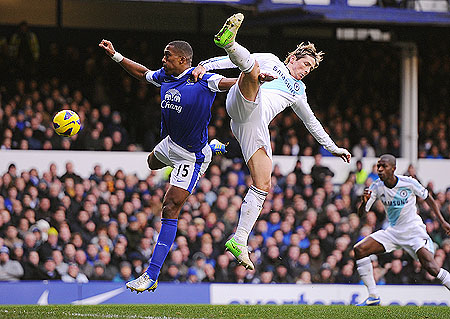Sylvain Distin of Everton and Fernando Torres of Chelsea vie for possession during their Premier League match on Sunday