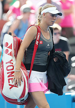 Caroline Wozniacki leaves the court after losing against Ksenia Pervak