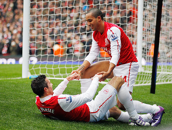 Theo Walcott and Robin van Persie of Arsenal celebrate