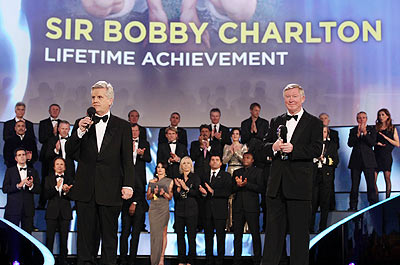 Sir Alex Ferguson with TV Presenter Steve Rider on stage while accepting the Laureus Lifetime Achievement Award on behalf of Sir Bobby Charlton