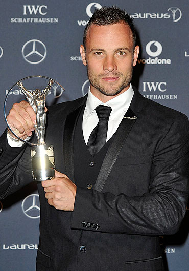Athlete Oscar Pistorius with his Laureus World Sportsperson of the Year with a Disability trophy