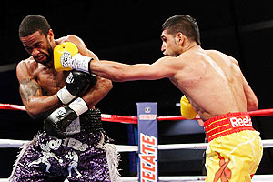 Amir Khan connects with a left punch to the head of Lamont Peterson