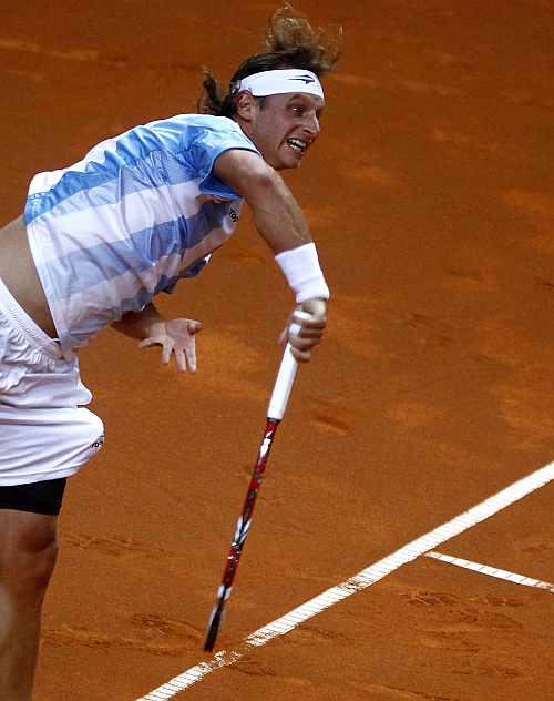 David Nalbandian of Argentina serves to Florian Mayer of Germany during their first round Davis Cup tennis match in Bamberg