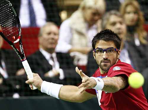 Janko Tipsarevic of Serbia hits a return to Prpic of Sweden during their match at the Davis Cup tennis tournament in Nis