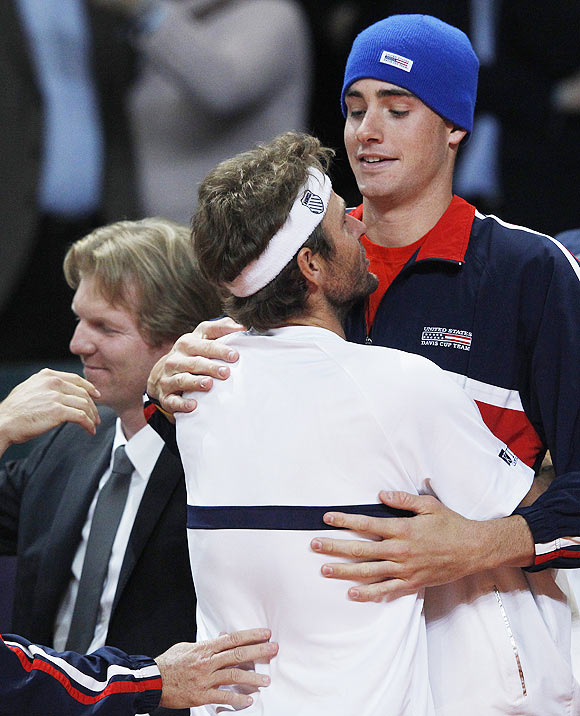 Mardy Fish (centre) of the US celebrates with team-mate after winning the Davis Cup doubles tennis match