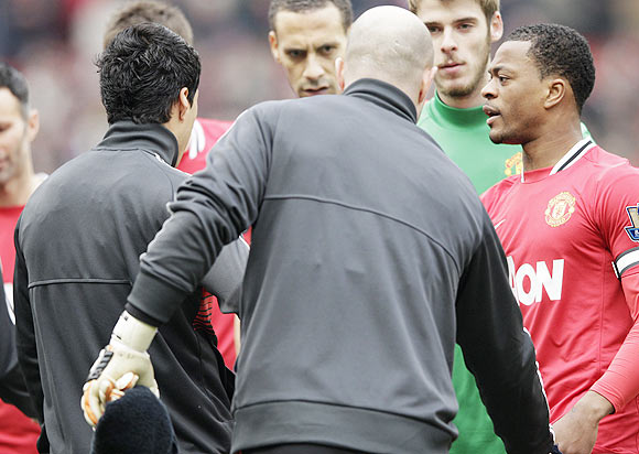 Manchester United's Patrice Evra (right) reacts after Liverpool's Luis Suarez (left) ignored his handshake