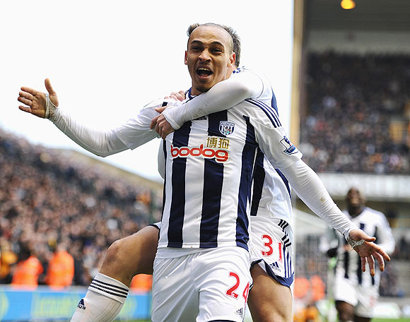 Peter Odemwingie of West Bromwich celebrates with teammate Simon Cox after scoring against Wolverhampton Wanderers on Sunday