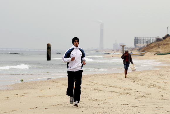 Gaza runner Bahaa al-Farra trains on a beach in Gaza City