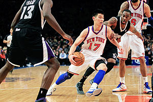 Jeremy Lin of the New York Knicks drives past Marcus Thornton of the Sacramento Kings during their NBA match at Madison Square Garden in New York City on Wednesday