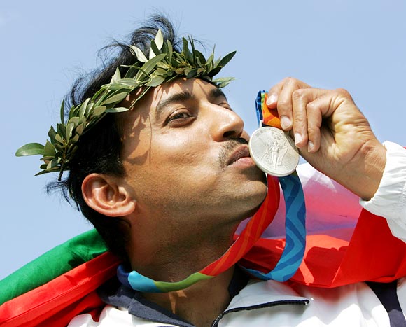 Rajyavardhan Singh Rathore kisses the silver medal he won at the Athens Olympics in 2004